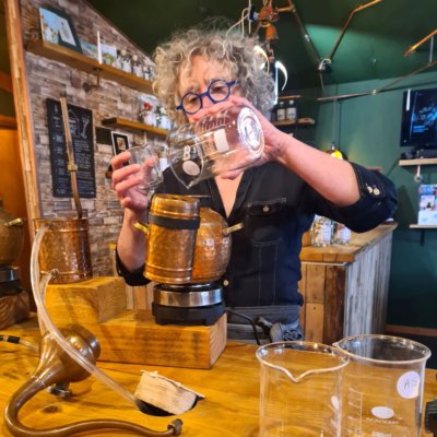 Zoe adding botanicals to a mini still.